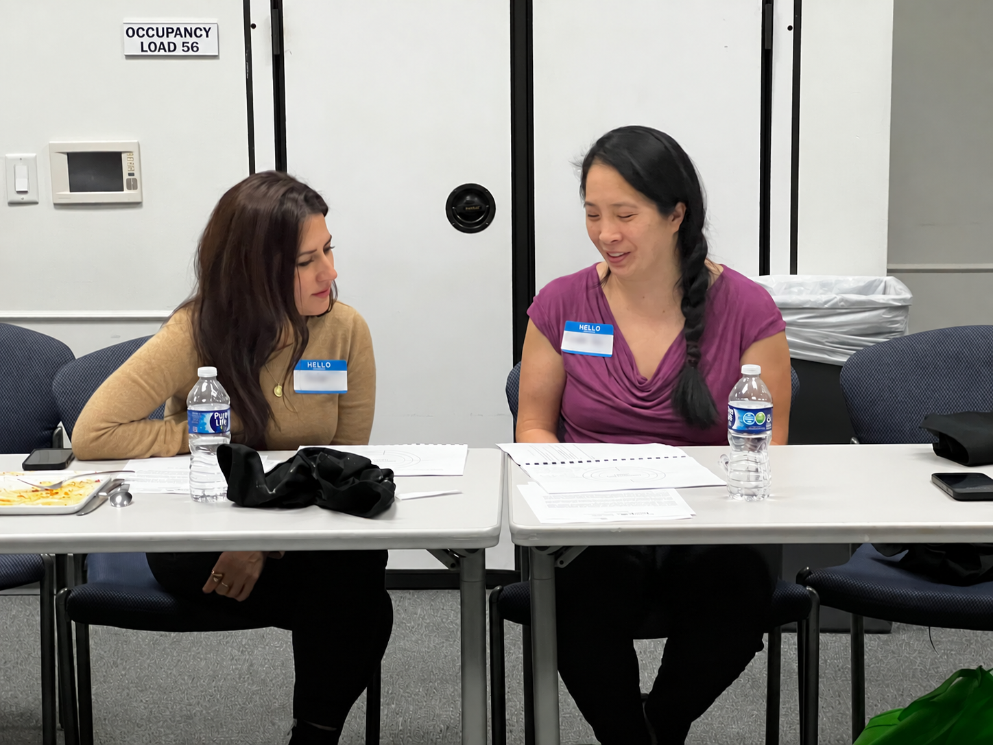 Two Dining with Purpose participants working through session materials together at Houston Food Bank.