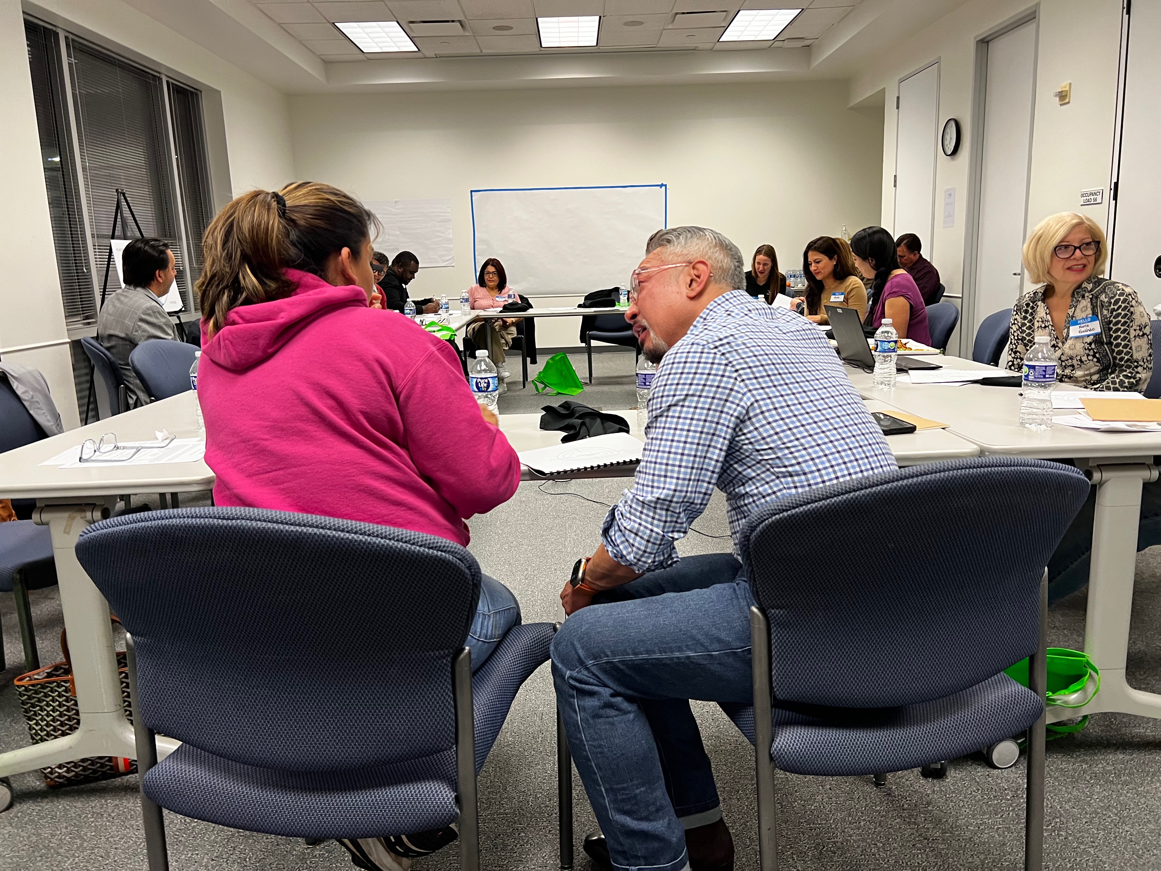 Dining with Purpose participants exchanging ideas around the table at Houston Food Bank.